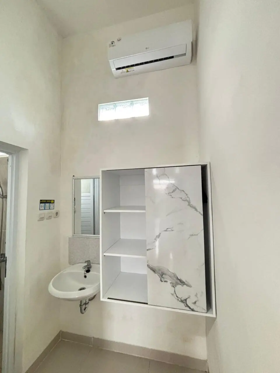 An air-conditioned room with storage and an en-suite bathroom.